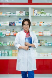 Pharmacist smiling in front of medications
