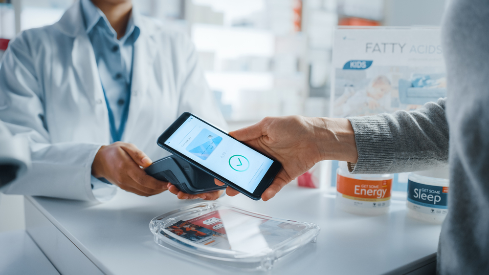 Pharmacist and customer completing a transaction