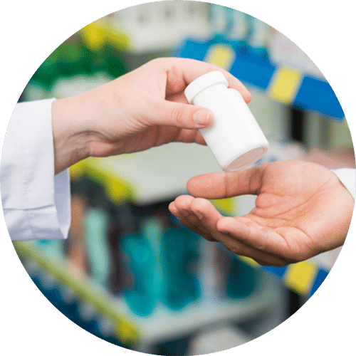 A bottle of medication being exchanged between hands