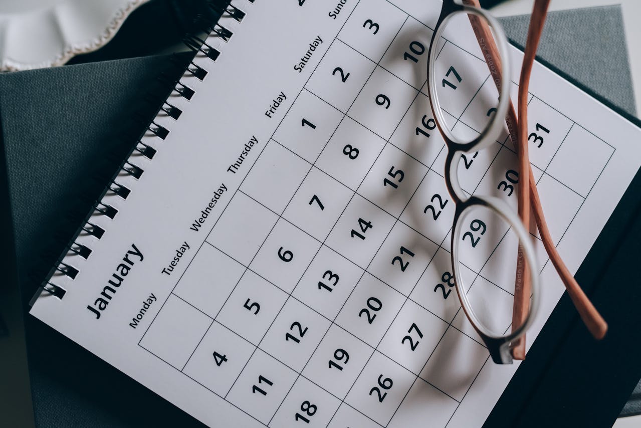 Calendar with a pair of eyeglasses resting on top