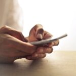 Close-up of hands using a smartphone to access prescriptions