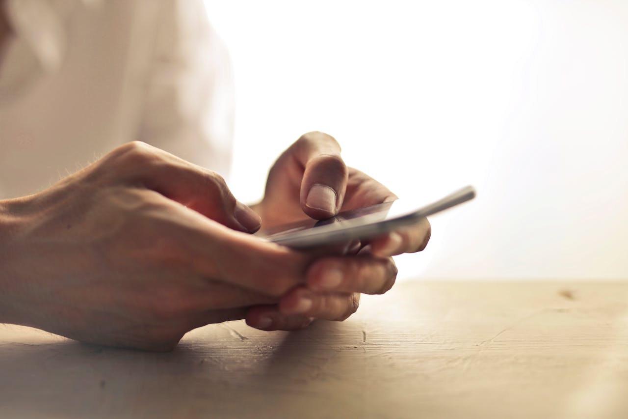 Close-up of hands using a smartphone to access prescriptions