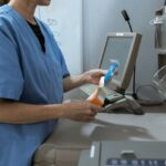 A medical professional using pharmacy software to dispense medication