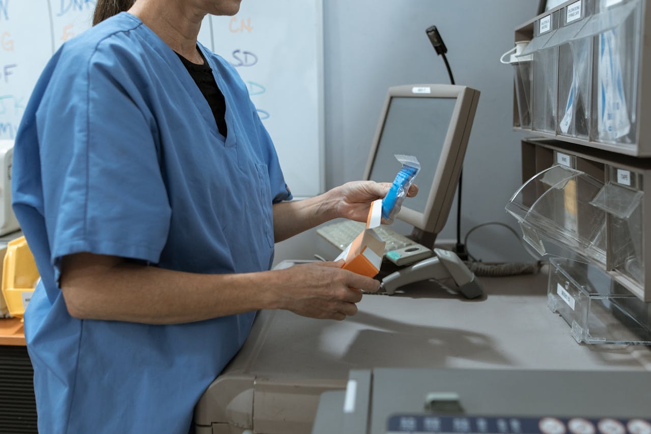 A medical professional using pharmacy software to dispense medication