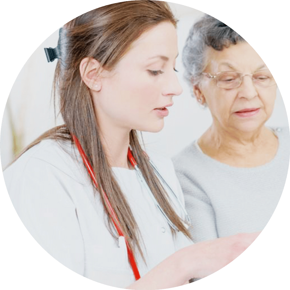 A younger woman in doctor's clothing seems to be helping an elderly lady