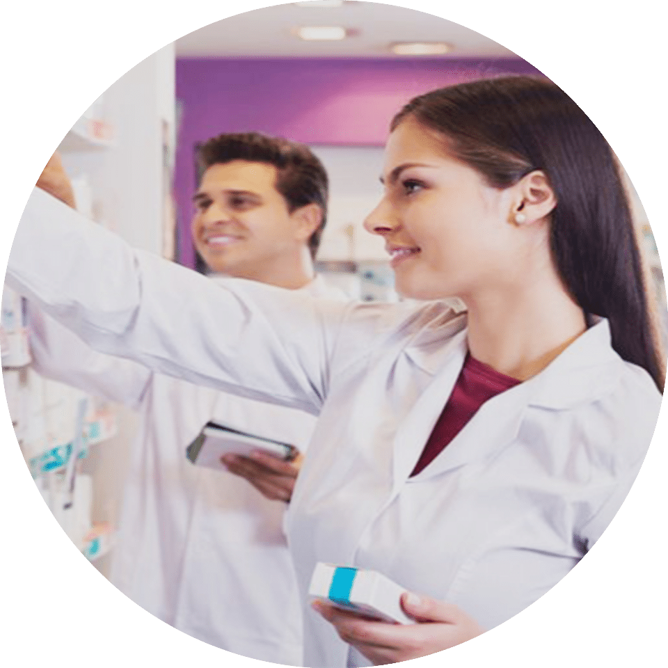 Two pharmacists shelving medicine