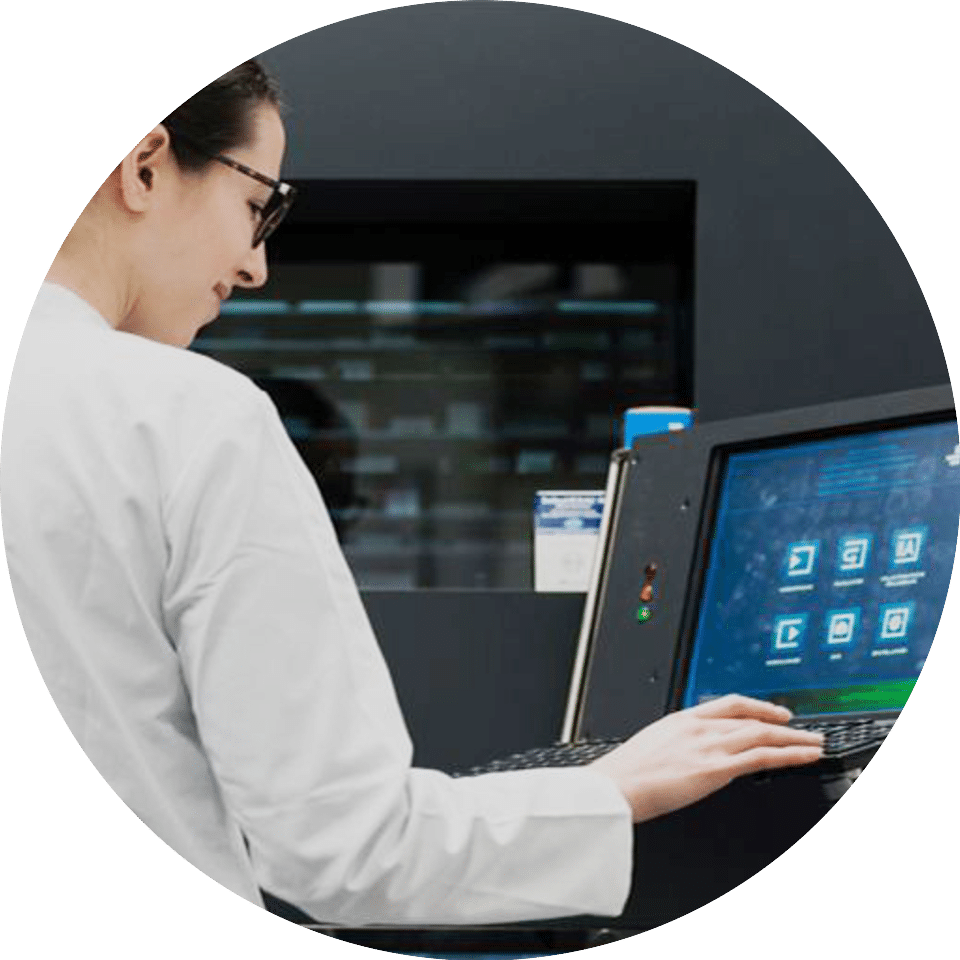 A woman operates a computerized system with a smile