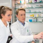 Two pharmacists learning how to use pharmacy software