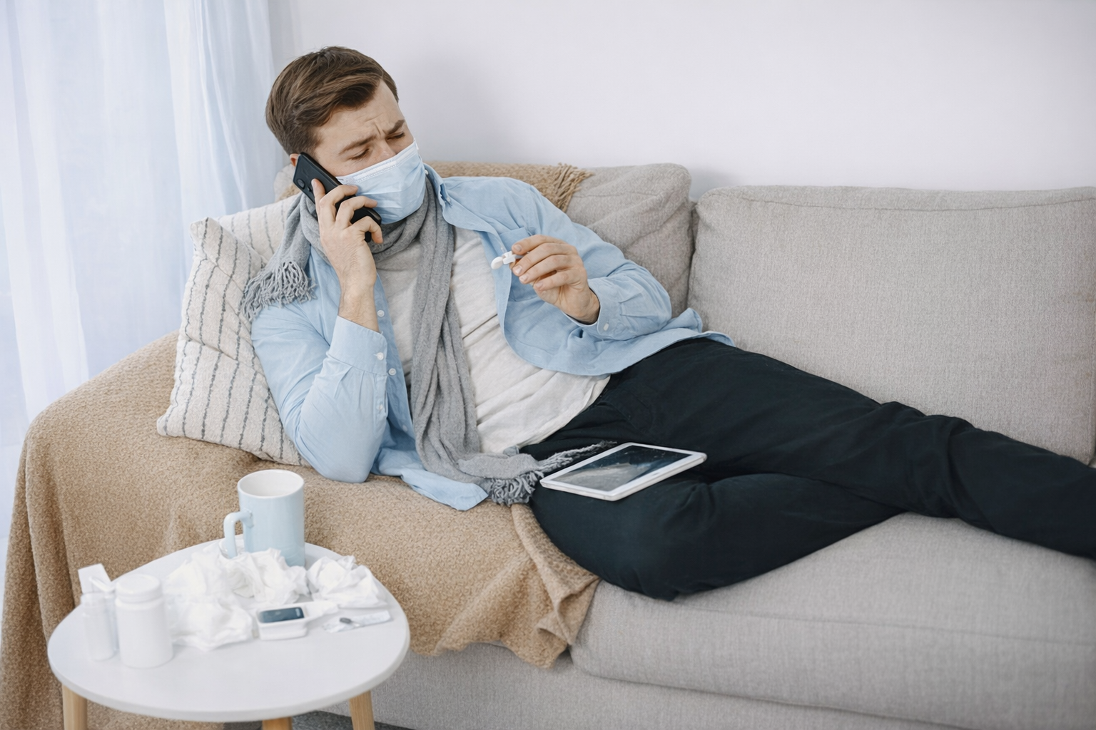sick-man-on-the-phone-with-his-pharmacist Sick man on the phone with his pharmacist using an app on his tablet