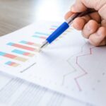 Pharmacist analyzing profits on a graph chart