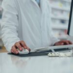 a pharmacist using software to automate tasks
