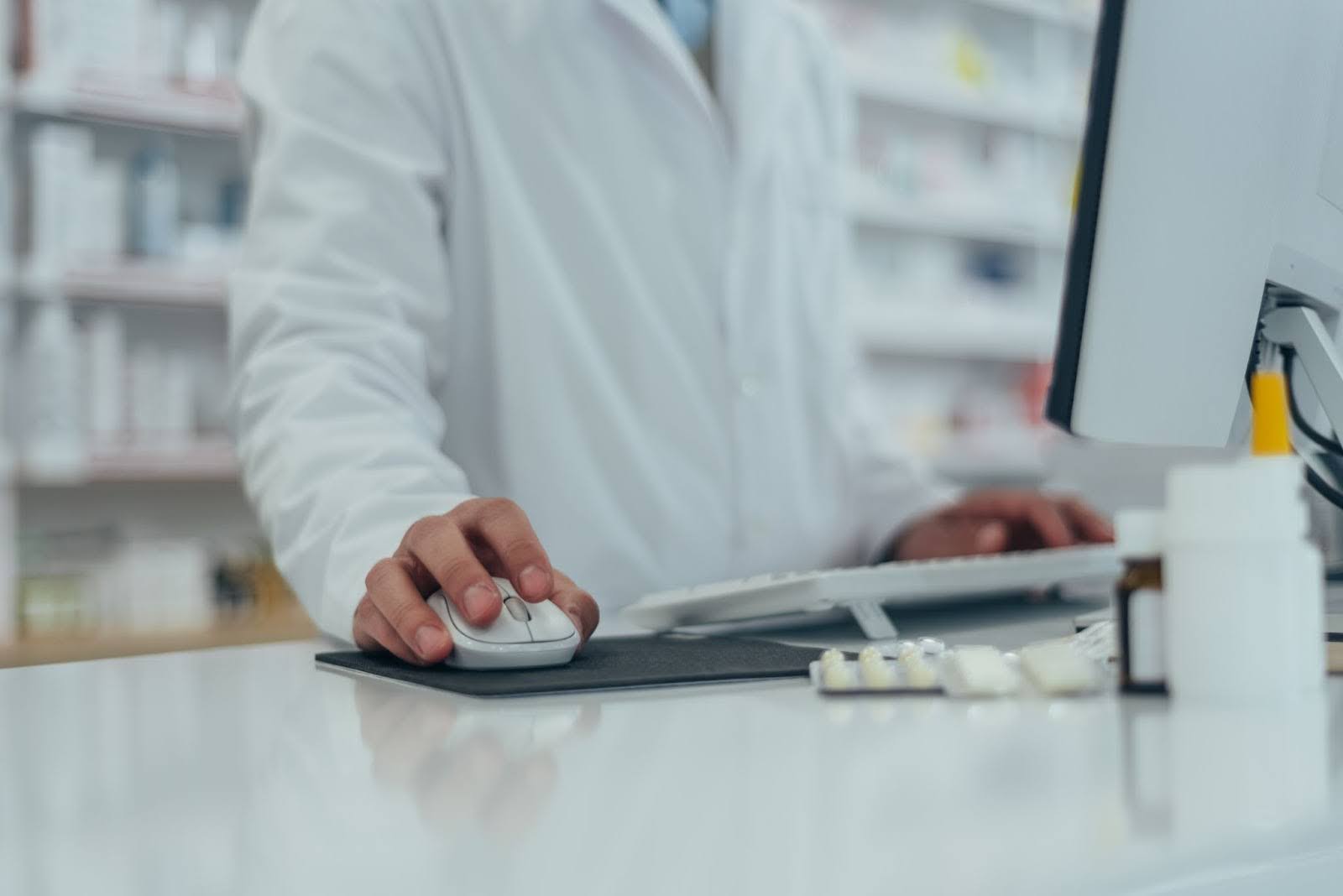 a pharmacist using software to automate tasks